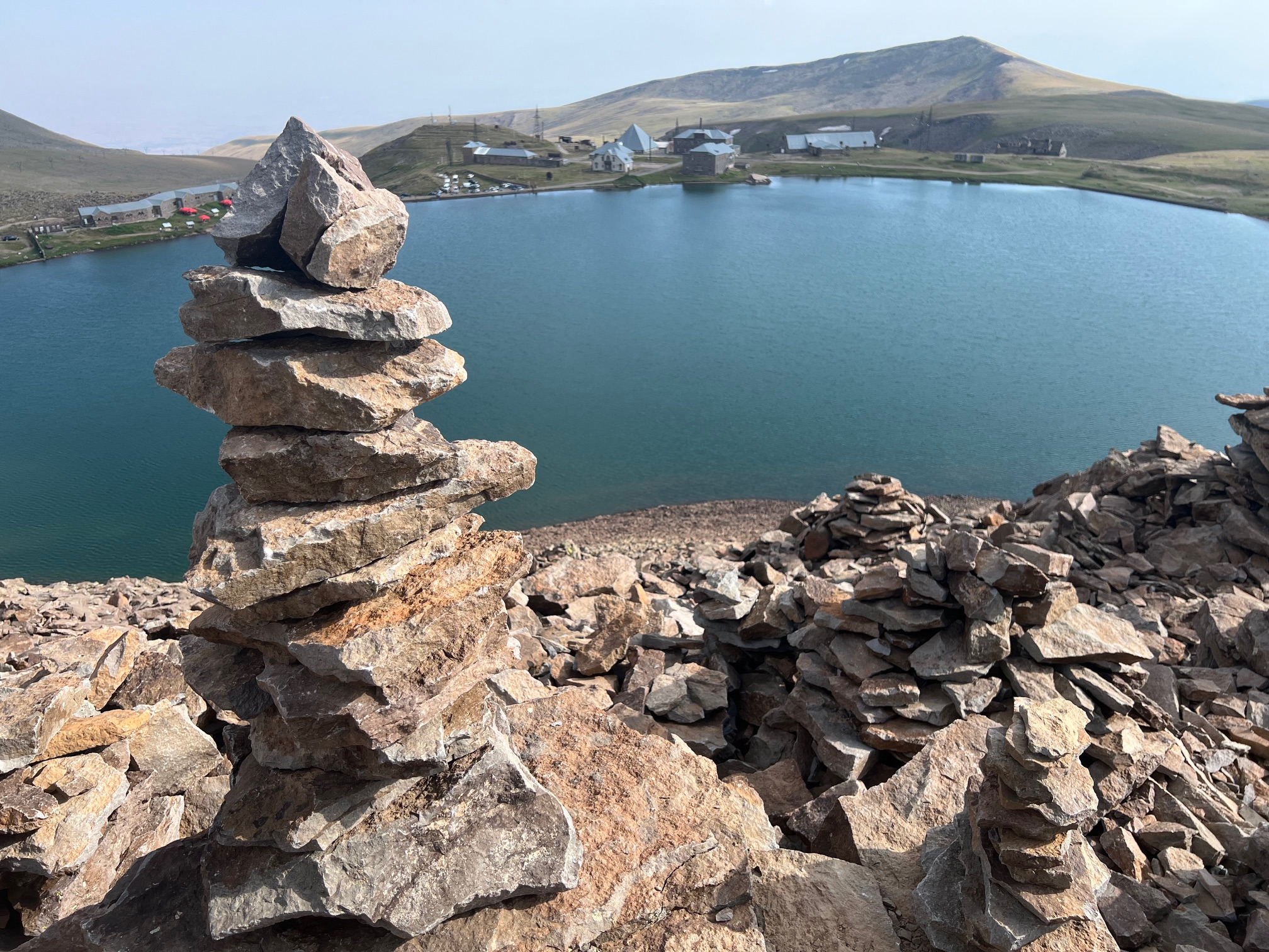 We may be told not to build rock piles, but perhaps at a research station investigating lightning it is different. The unfortunately named Kari Lake in the midground and the Space Environmental Center at Mount Aragats in the distance